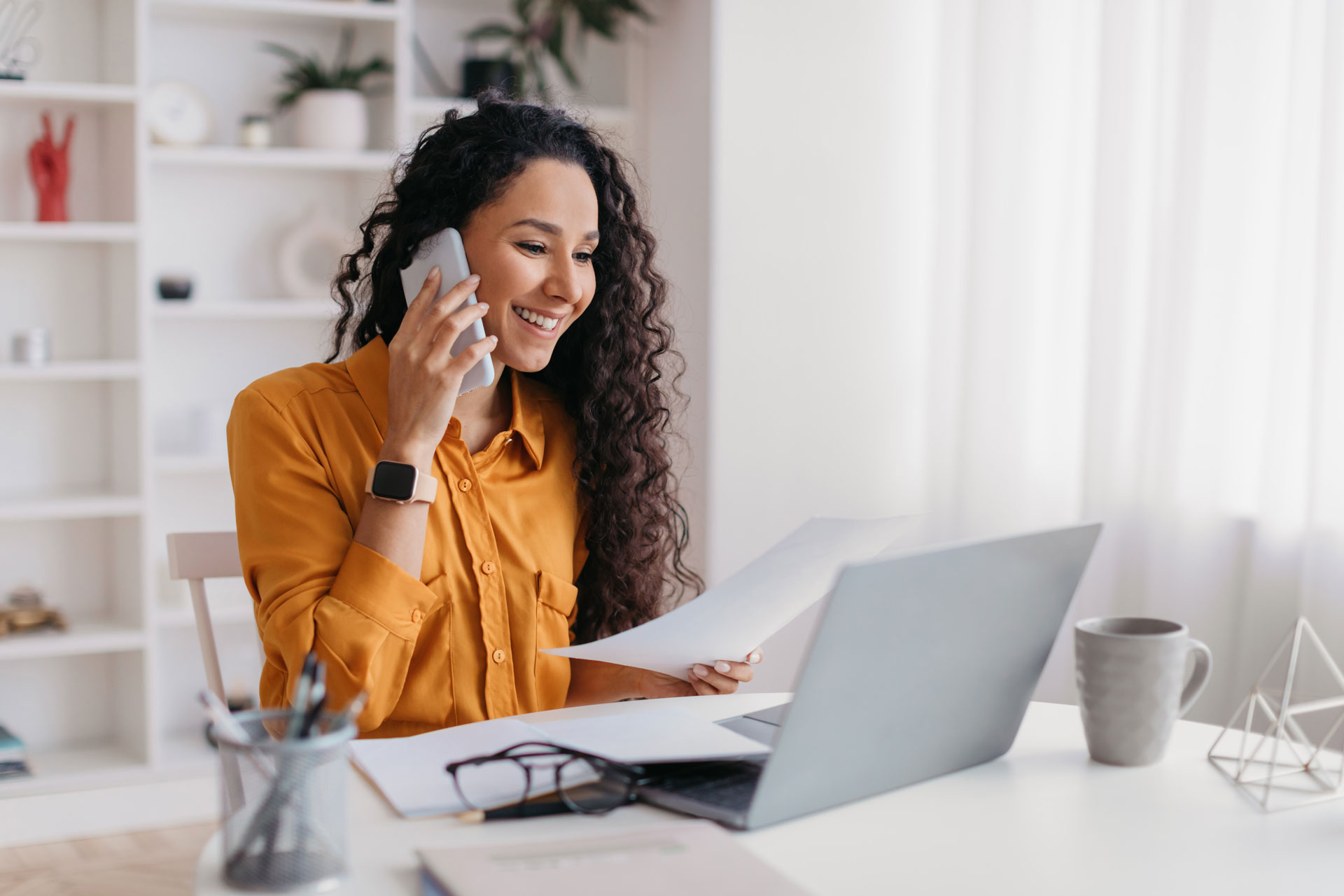 A woman in a home office engaging in Omnichannel Marketing efforts from a Financial Institution.