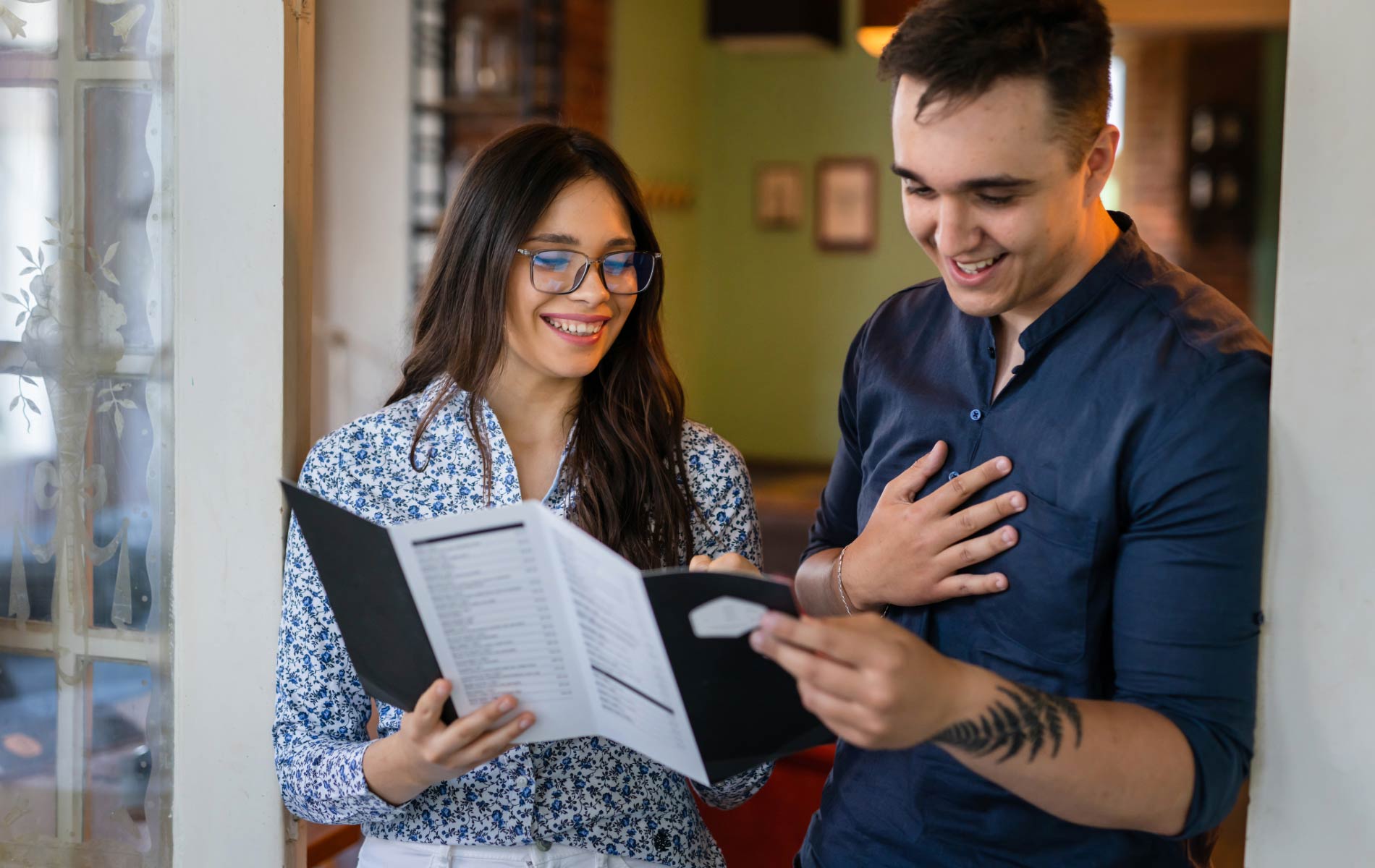 A couple reviewing a brochure that Enhances Brand Messaging and Connection